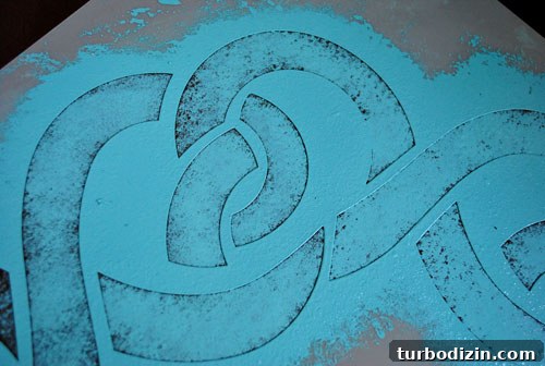 How to Paint and Stencil a Concrete Floor for Lasting Results 6 Dabbing excess paint on cardboard