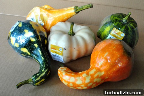 White painted faux gourds on a tabletop