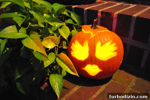 Baby Handprint Pumpkin Craft for Halloween Keepsake 9 Lit pumpkin with handprint face