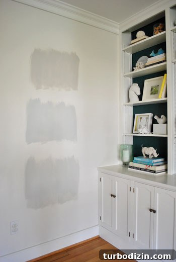 How to Choose the Perfect Gray Paint Color for Your Home 3 test areas of three Benjamin Moore gray paint colors applies to an area of white wall
