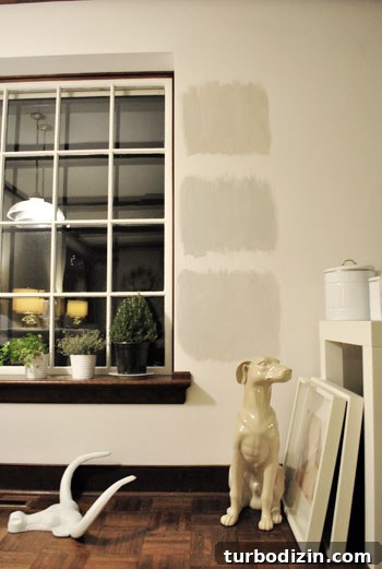 How to Choose the Perfect Gray Paint Color for Your Home 8 testing paint colors on a wall during night time when artificial light is used instead of natural light