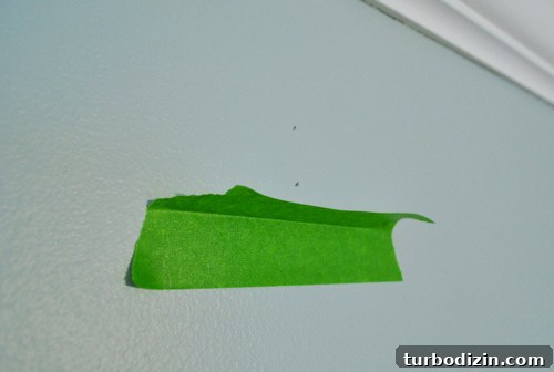 Painter's tape shelf catching drill dust