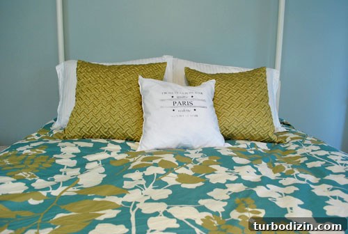 Greeny-gold pillows on bed