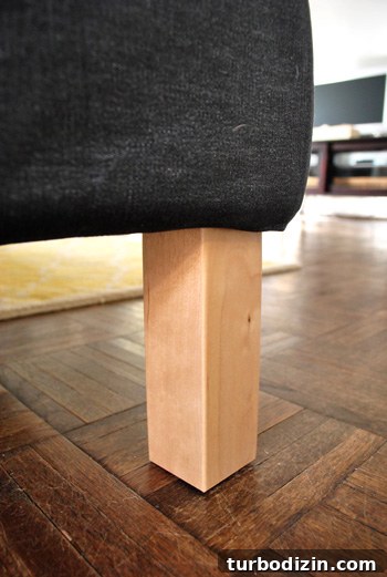 How We Assembled the IKEA Karlstad Sectional Sofa Step-by-Step 9 close up detail of ikea sectional sofa legs in unfinished blonde wood