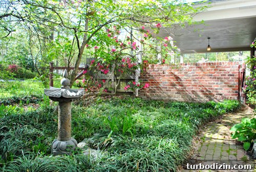 Install a Rain Barrel: Step-by-Step Guide for Your Garden 5 Garden area behind carport