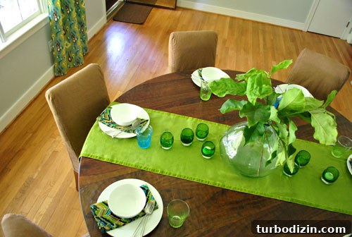 Dining table styled with branches and place settings