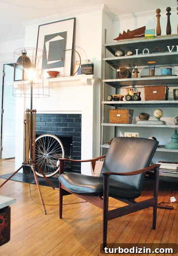 View from teal sofa to fireplace and lamp