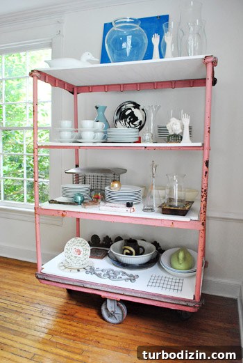 Pink cart on casters with wooden duck