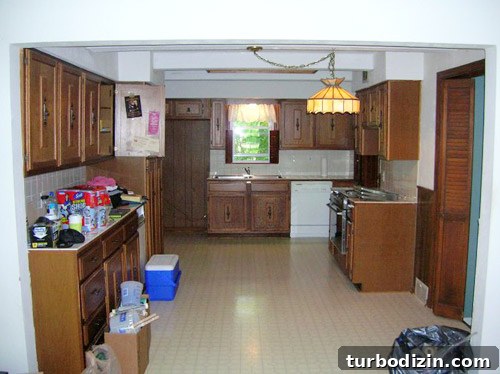 Blue and White DIY Kitchen Remodel: Step-by-Step Guide and Tips 2 Before photo of 1950s kitchen showing lamp and beam