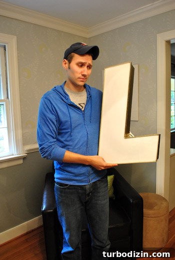 The letter L hanging in the room