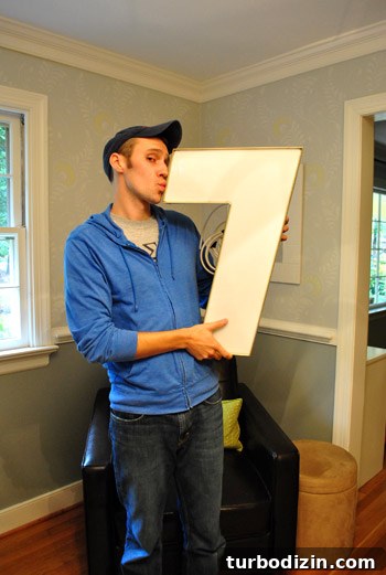 John posing with the sign letter