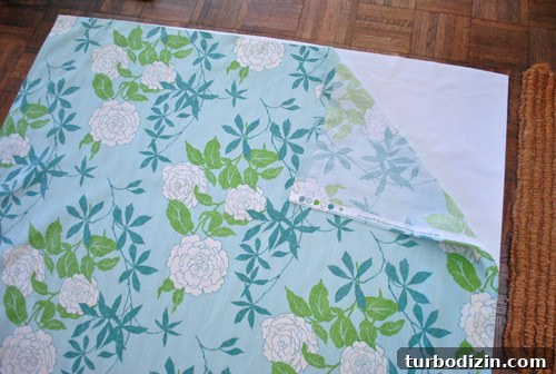 how an affordable blackout fabric liner is layered behind colorful floral fabric to create DIY blackout curtains