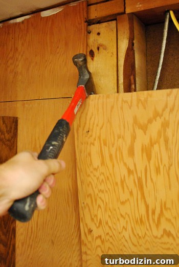 How to Remove Old Backsplash Tile and Plywood Safely 11 Prying plywood off wall