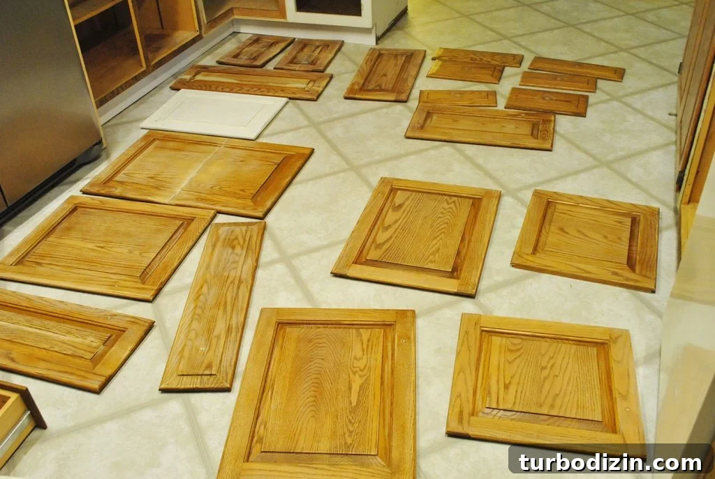 How to Paint Kitchen Cabinets Like a Pro: Step-by-Step Guide 5 Cabinet Doors Spread Out On Kitchen Floor For Painting