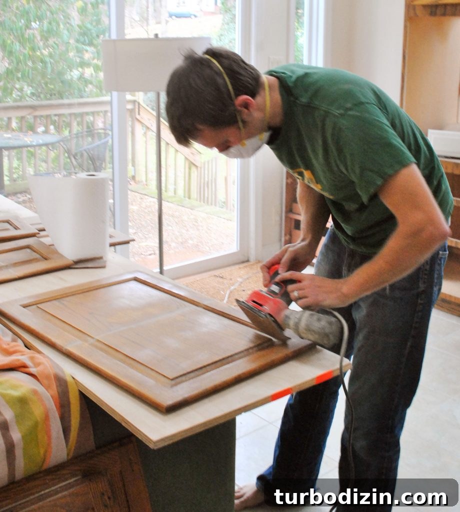 How to Paint Kitchen Cabinets Like a Pro: Step-by-Step Guide 7 John Sanding Wood Kitchen Cabinet