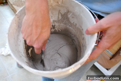 Using rubber float to press grout into joints