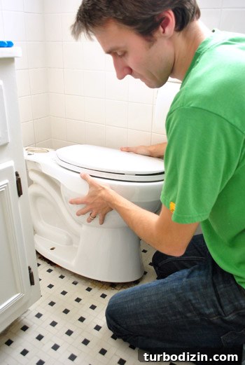 Fix a Wobbly Toilet: Quick Steps to Stabilize It Safely 11 John carefully removing toilet bowl from floor
