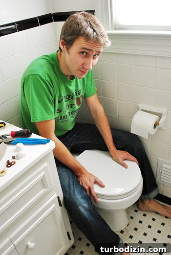 Fix a Wobbly Toilet: Quick Steps to Stabilize It Safely 20 John applying pressure to toilet bow to secure wax ring in place