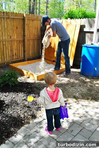 Child waiting to play in sandbox