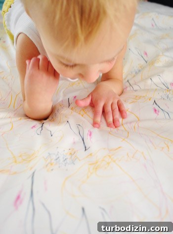 Create Custom Fabric from Your Child's Artwork: A Step-by-Step Guide 23 Clara looking at fabric