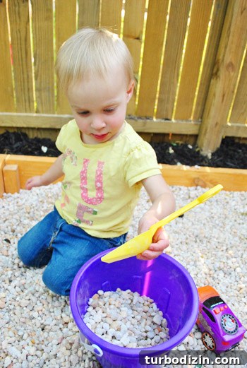 How to Build a DIY Rock Box for Portable Music Playback 11 Child playing in rock sandbox