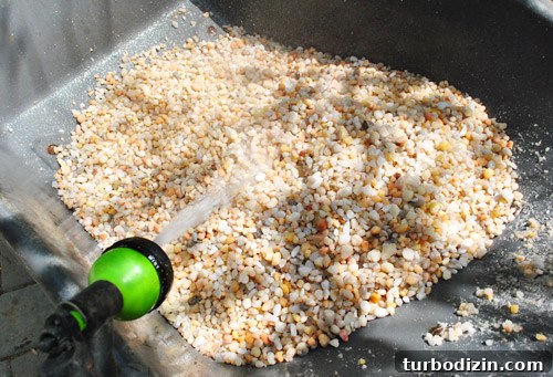 How to Build a DIY Rock Box for Portable Music Playback 7 Washing pebbles in wheelbarrow