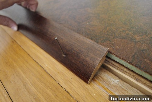 How to Install Floor Trim, Transition Strips, and Reducers 9 Transition positioned in doorway
