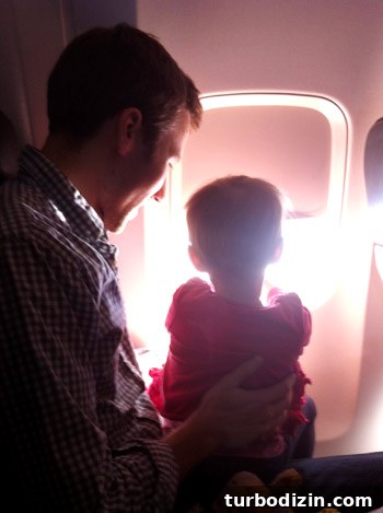 flying with toddler looking out the window