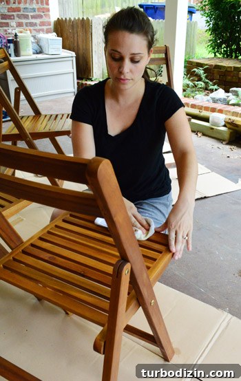 Protect Outdoor Furniture: Varnish vs. Teak Oil Guide 9 Applying oil to chair