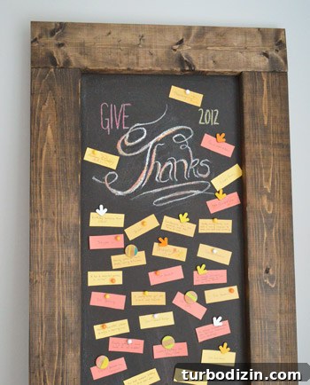 Create a Thanksgiving Gratitude Chalkboard for Your Home 5 Leaning DIY magnetic chalkboard with Give Thanks lettering in chalk with gratitude notes