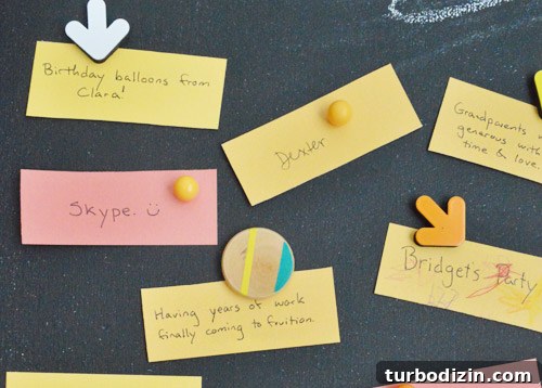 Create a Thanksgiving Gratitude Chalkboard for Your Home 8 Magnetic chalkboard with colorful Thanksgiving gratitude notes held up with fun magnets