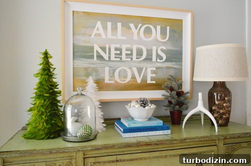 Feather trees and small evergreen on console table