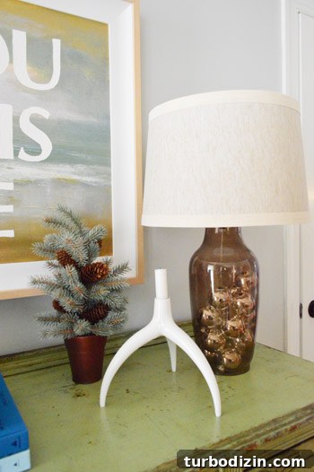 Glass lamp filled with silver ornaments