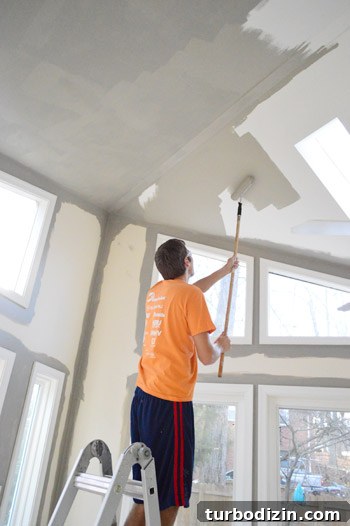 How to Paint Very High Vaulted Ceilings Safely and Efficiently 11 Using roller pole on ceiling