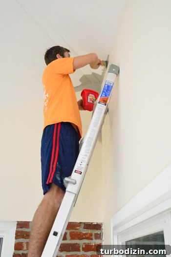 How to Paint Very High Vaulted Ceilings Safely and Efficiently 8 Using ladder to paint ceiling