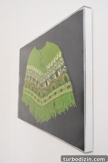 Framing Kids’ Clothes and Adding Playful Wall Hooks for Decor 8 Framed poncho on the wall