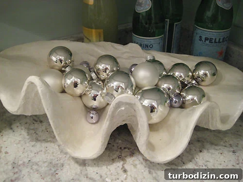 Clam shell bowl filled with silver ornaments