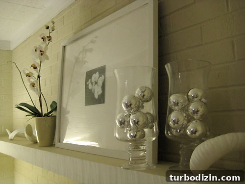 Hurricane vases filled with silver balls