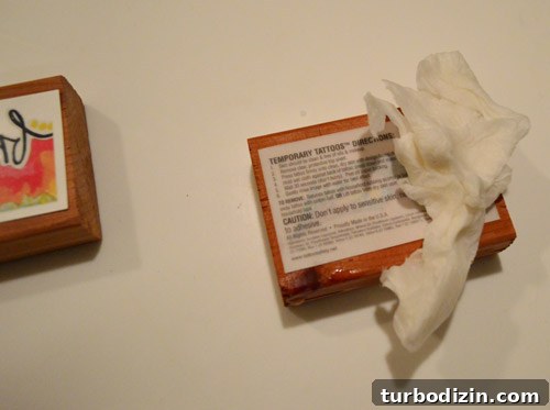 Applying tattoo to cedar block