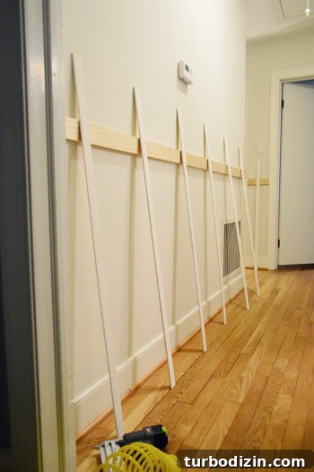 Board and Batten Wall Paneling for Under $60 10 planning placement of vertical planks or battens in DIY board and batten project