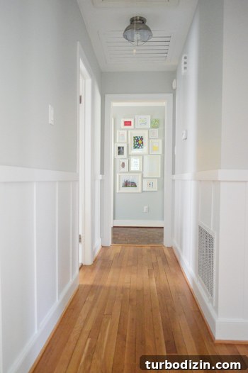 Board and Batten Wall Paneling for Under $60 18 gray hallway with white board and batten trim molding looking at picture frame gallery