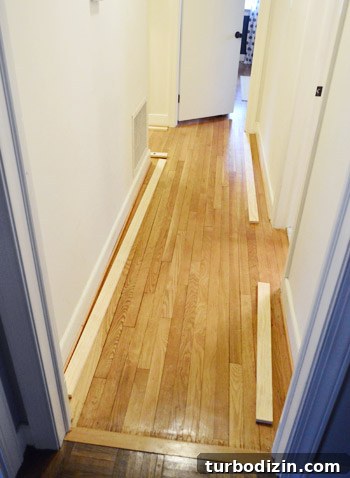 Board and Batten Wall Paneling for Under $60 7 1x3 pine boards cut and laid out to plan top ledge for board and batten hallway installation
