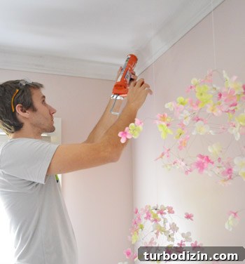 Crown Molding Installation Guide: Step-by-Step Tips for Perfect Results 15 John adding caulk against ceiling where crown molding has slight gap