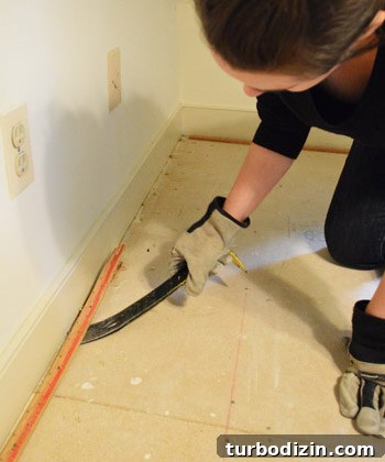 prying up carpet tack strip with crowbar