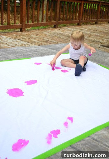 How to Create a Hand-Painted Fabric Backdrop at Home 8 Child painting fabric