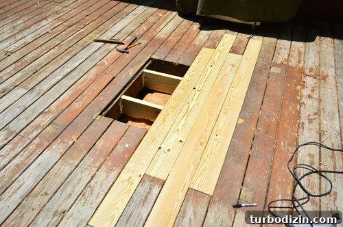 Fix a Hole in Your Deck: Step-by-Step Repair Guide 13 Patched hole in wooden deck with new boards