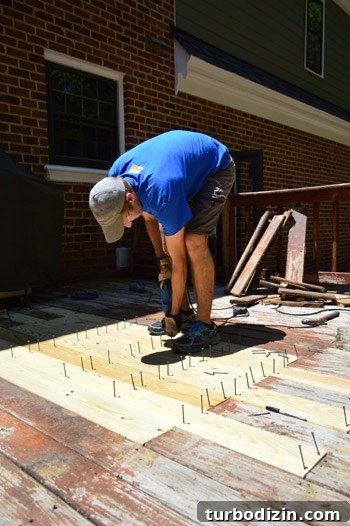 Fix a Hole in Your Deck: Step-by-Step Repair Guide 14 John screwing in new deck boards