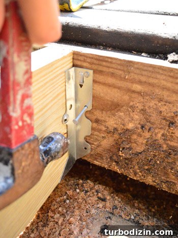 Fix a Hole in Your Deck: Step-by-Step Repair Guide 6 Nailing in metal hangers to repair a hole in the deck