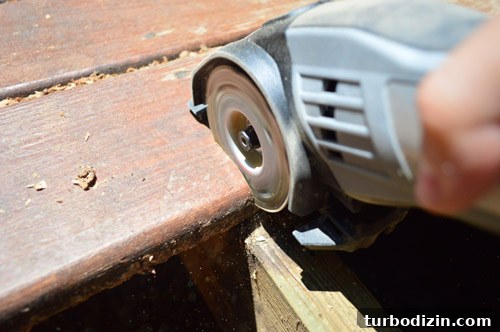 Fix a Hole in Your Deck: Step-by-Step Repair Guide 9 Dremel Sawmax tool using to cut deck board