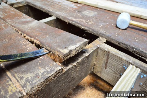 Fix a Hole in Your Deck: Step-by-Step Repair Guide 10 Prying up deck board with crowbar